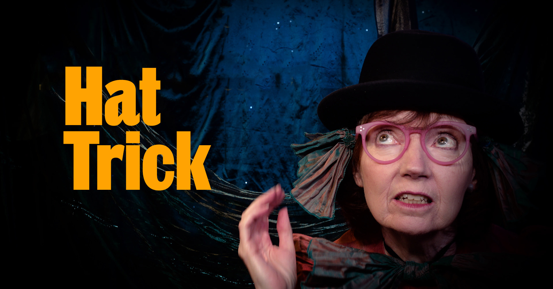 Hat Trick is written in yellow on an image of a woman wearing a black bowler hat and red glasses looks up
